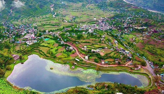 Green hills, settlement and lake in Rukum